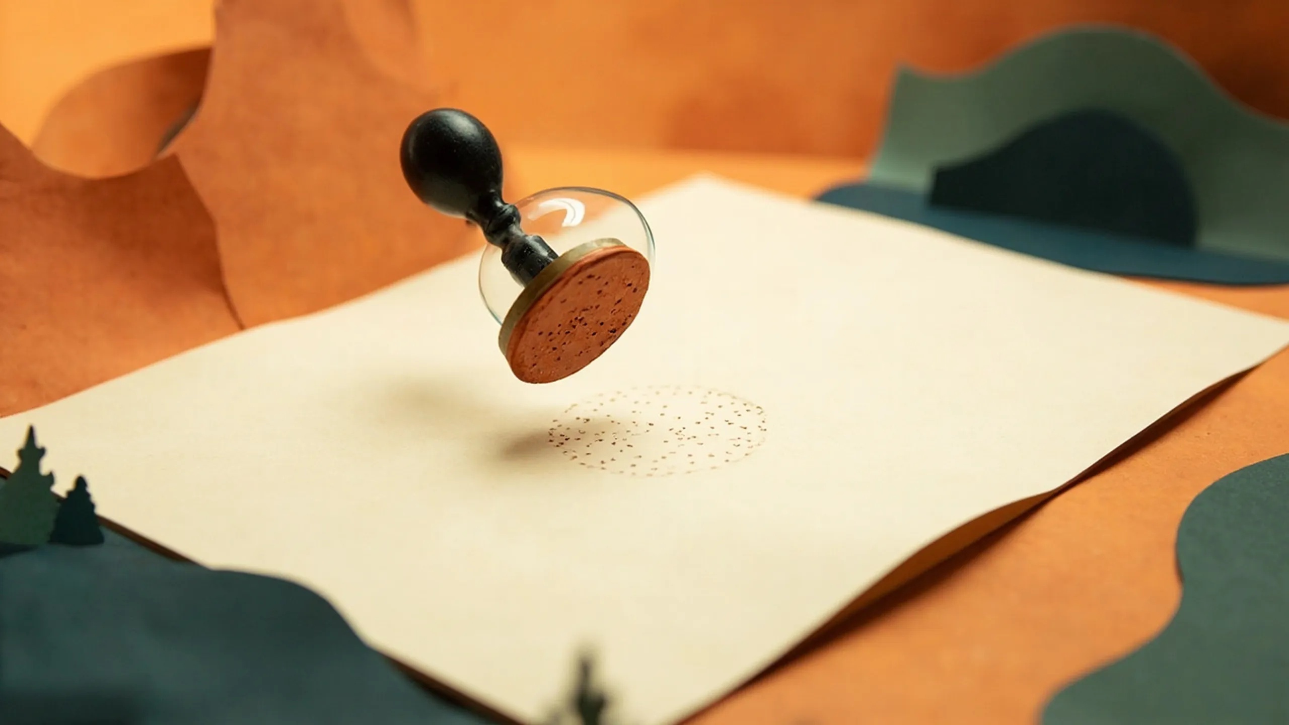 Paper-cutout illustration of a rubber stamp pressing a faint hidden seal into a sheet of paper, revealed under a magnifying glass